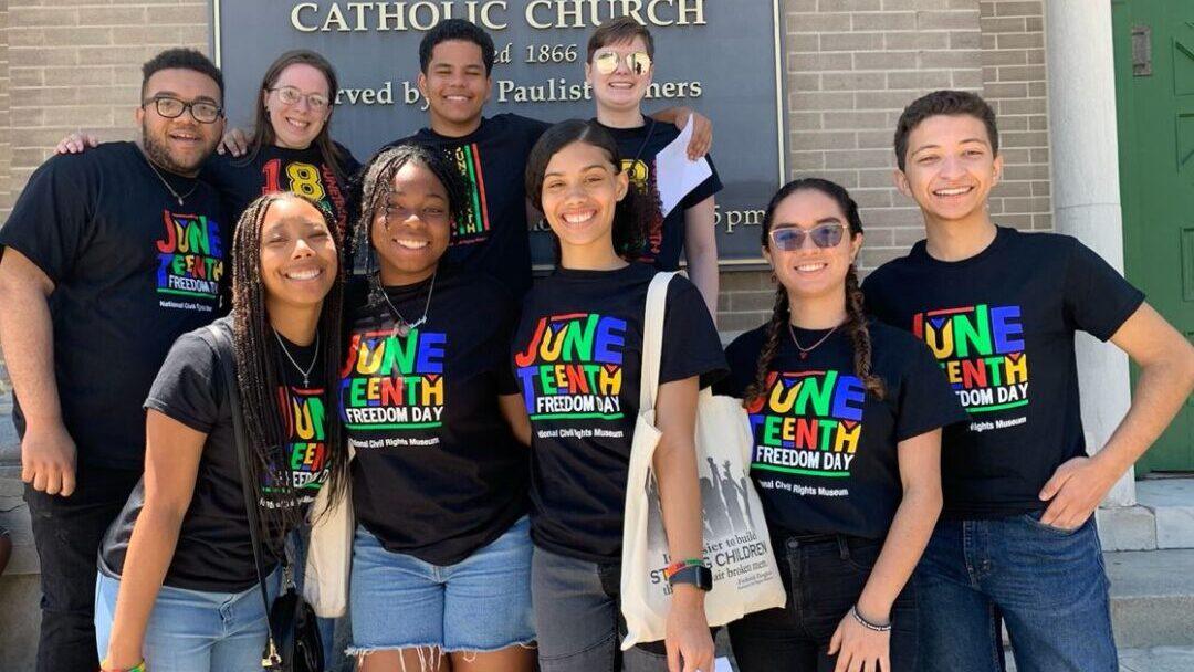 group of young people wearing black t shirts